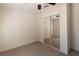 This bedroom features neutral carpet and mirrored closet doors, with a ceiling fan for added comfort at 5142 Serene Sq, New Port Richey, FL 34653