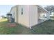 View of the house exterior, showing the side of the home and a covered porch at 5142 Serene Sq, New Port Richey, FL 34653