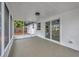 A screened patio with concrete flooring, a ceiling fan, and sliding glass doors to the backyard at 8201 Penwood Dr, Port Richey, FL 34668