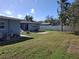 View of back yard with a small patio for outdoor seating and a fenced in back yard at 1229 75Th N Ave, St Petersburg, FL 33702