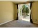 Inviting bedroom featuring private balcony with palm tree views and carpeted floors at 130 Banyan Bay Dr, St Petersburg, FL 33705