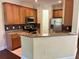 Bright kitchen featuring stainless steel appliances, granite counters, and wood cabinets at 130 Banyan Bay Dr, St Petersburg, FL 33705