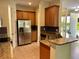 A kitchen featuring stainless steel appliances, granite countertops, and warm wood cabinetry at 130 Banyan Bay Dr, St Petersburg, FL 33705