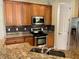 Well-equipped kitchen featuring granite countertops, stainless steel appliances, and tile backsplash at 130 Banyan Bay Dr, St Petersburg, FL 33705