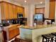 A kitchen area featuring wooden cabinets, granite counters, and stainless steel appliances at 130 Banyan Bay Dr, St Petersburg, FL 33705