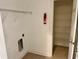 Functional laundry room with shelving, tile floors and fire extinguisher for added safety at 130 Banyan Bay Dr, St Petersburg, FL 33705