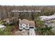 Aerial view of a charming home showcasing its location, lush landscaping and serene surroundings at 19018 Geraci Rd, Lutz, FL 33548