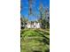 Expansive backyard with mature trees providing ample shade and privacy for relaxing or entertaining at 19018 Geraci Rd, Lutz, FL 33548
