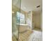 Elegant bathroom with a freestanding tub, decorative tile, and natural light from the large window at 19018 Geraci Rd, Lutz, FL 33548