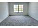 Neutral bedroom featuring carpet, a window and neutral walls at 19018 Geraci Rd, Lutz, FL 33548