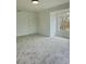 A bright, carpeted room with a large window offers natural light at 19018 Geraci Rd, Lutz, FL 33548