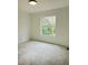 Carpeted bedroom bathed in natural light with a large window view at 19018 Geraci Rd, Lutz, FL 33548
