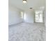 Bright bedroom with neutral carpet, white walls, and natural light streaming through the windows, cozy and inviting at 19018 Geraci Rd, Lutz, FL 33548
