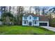 Elegant two-story home with an attached garage, lush green lawn and a canopy of mature trees at 19018 Geraci Rd, Lutz, FL 33548