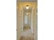 Hallway with neutral carpet and white walls featuring multiple doors at 19018 Geraci Rd, Lutz, FL 33548