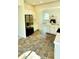 Modern kitchen featuring stainless steel appliances, white cabinetry, and colorful tiled flooring at 19018 Geraci Rd, Lutz, FL 33548