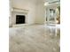 Sunlit living room with tile flooring, a cozy fireplace, and sliding doors leading to a backyard at 19018 Geraci Rd, Lutz, FL 33548