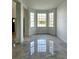 Sun-drenched living room featuring glossy tile floors and large windows for ample natural light and views at 19018 Geraci Rd, Lutz, FL 33548