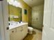 Bright bathroom featuring a glass shower, white vanity, and decorative wall art at 19417 Gulf Blvd # C210, Indian Shores, FL 33785
