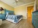 Cozy bedroom with a queen-size bed, coastal decor, and wood-look floors at 19417 Gulf Blvd # C210, Indian Shores, FL 33785