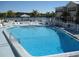 Inviting outdoor pool area with ample lounge chairs, beachfront access, and a scenic waterfront view at 19417 Gulf Blvd # C210, Indian Shores, FL 33785