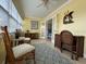 Bright sunroom with wicker furniture, a desk, and plenty of natural light at 19417 Gulf Blvd # C210, Indian Shores, FL 33785