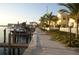 Beautiful waterfront property featuring a private dock and scenic walkway lined with palm trees at 19417 Gulf Blvd # C210, Indian Shores, FL 33785
