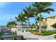 Scenic waterfront complex with lush palm trees, picturesque walkway, and private boat docks for residents at 19417 Gulf Blvd # C210, Indian Shores, FL 33785