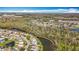 Panoramic aerial view of a sprawling residential community featuring winding waterways amidst verdant forestry at 27500 Breakers Dr, Wesley Chapel, FL 33544