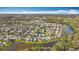 Expansive aerial view of a residential community, with homes surrounding ponds and green spaces at 27500 Breakers Dr, Wesley Chapel, FL 33544