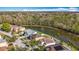 Aerial shot showcasing homes along a tranquil lake, some featuring private pools and verdant lawns at 27500 Breakers Dr, Wesley Chapel, FL 33544