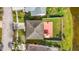 Aerial shot of home showing roof, backyard patio with umbrella, white fence, landscaping, and driveway at 27500 N Breakers Dr, Wesley Chapel, FL 33544