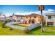 Backyard aerial view shows patio with gazebo, fenced yard and green grass, and neighboring homes at 27500 Breakers Dr, Wesley Chapel, FL 33544