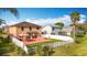 Aerial backyard view showcases a well-maintained lawn, a patio with a gazebo, and a white fence at 27500 Breakers Dr, Wesley Chapel, FL 33544