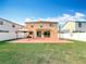 Large grassy backyard with a gazebo-covered patio and a basketball hoop, enclosed by a white fence at 27500 Breakers Dr, Wesley Chapel, FL 33544