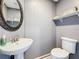 Half bathroom features a pedestal sink and modern fixtures at 27500 Breakers Dr, Wesley Chapel, FL 33544