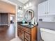 Bathroom featuring black granite countertop, dark wood vanity, mirror and tile flooring at 27500 Breakers Dr, Wesley Chapel, FL 33544
