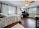 Spacious bedroom featuring a ceiling fan, windows, and modern decor at 27500 Breakers Dr, Wesley Chapel, FL 33544