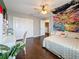 Comfortable bedroom featuring a ceiling fan, closet, stylish decor, and dark wood floors at 27500 Breakers Dr, Wesley Chapel, FL 33544
