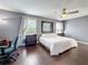 Bright, well-lit primary bedroom with hardwood floors, a large window, and neutral wall paint at 27500 Breakers Dr, Wesley Chapel, FL 33544