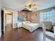 Charming bedroom featuring playful decor, natural light, and beautiful laminate flooring at 27500 Breakers Dr, Wesley Chapel, FL 33544