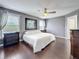 Spacious bedroom featuring hardwood floors, neutral walls, a ceiling fan, and two windows at 27500 Breakers Dr, Wesley Chapel, FL 33544