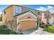 Stunning two-story home boasts a two-car garage, landscaped yard, and well-maintained exterior at 27500 Breakers Dr, Wesley Chapel, FL 33544