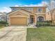 Attractive two-story home featuring a well-kept lawn, a spacious two car garage, and decorative details at 27500 Breakers Dr, Wesley Chapel, FL 33544