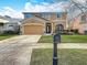 Charming two-story home with a well-maintained lawn and attractive landscaping at 27500 Breakers Dr, Wesley Chapel, FL 33544