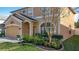 Well-maintained front yard with lush landscaping, a charming tree, and an inviting entrance to the home at 27500 Breakers Dr, Wesley Chapel, FL 33544