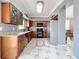 Spacious kitchen offers tile flooring, stainless steel refrigerator, and decorative wood cabinets at 27500 Breakers Dr, Wesley Chapel, FL 33544