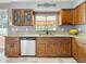 Kitchen featuring granite countertops, wooden cabinets, and a stainless steel dishwasher at 27500 Breakers Dr, Wesley Chapel, FL 33544