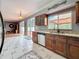 Beautiful kitchen features granite countertops, stainless steel appliances, and sliding glass doors at 27500 Breakers Dr, Wesley Chapel, FL 33544