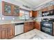 Well-lit kitchen with granite countertops, wooden cabinetry, and modern appliances at 27500 Breakers Dr, Wesley Chapel, FL 33544